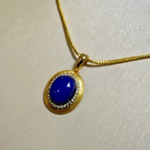 Golden Sands Lapis Lazuli Oval Pendant — gold-plated silver oval pendant with golden sand textured rim, micro-pave diamond halo, and natural lapis lazuli center by Meruisa Crystal
