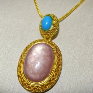 Lepidolite · Serenity Blue Apatite Pendant — 19.7mm natural Lepidolite cabochon in openwork gold-tone frame with Blue Apatite accent by Meruisa Crystal