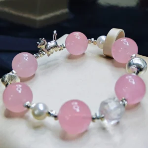 Whisker & Blush Rose Quartz Bracelet — 14.4mm natural rose quartz beads with shell pearl accents, square clear quartz, and silver cat charm by Meruisa Crystal